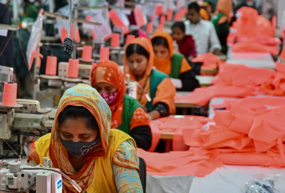 Garment workers sewing clothes at a Snowtex Group textile factory in Dhamrai, a sub-district in Dhaka. Taslima Akhter, from the Bangladesh Garment Workers’ Solidarity group, a labour rights organisation, says that “workers are struggling to maintain a minimum standard of living”.