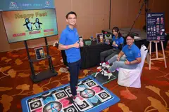 From left: Jonathon Leong, Fatin Sharafana, and Denise Caluza demonstrate their AI-powered rhythm game at Tech4City 2024.