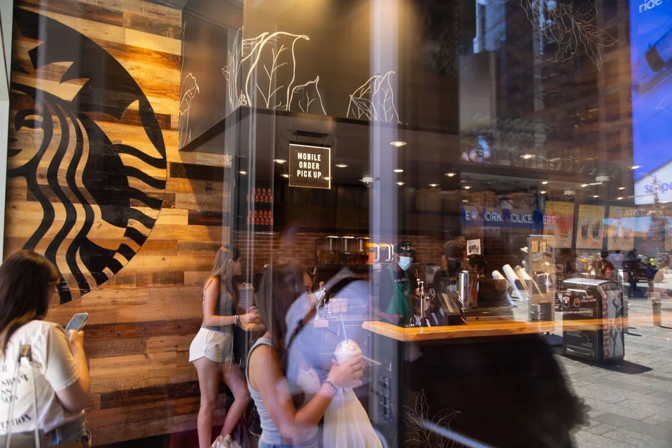 Starbucks’ business has taken a hit as consumers pressured by inflation and dwindling savings tighten their spending.