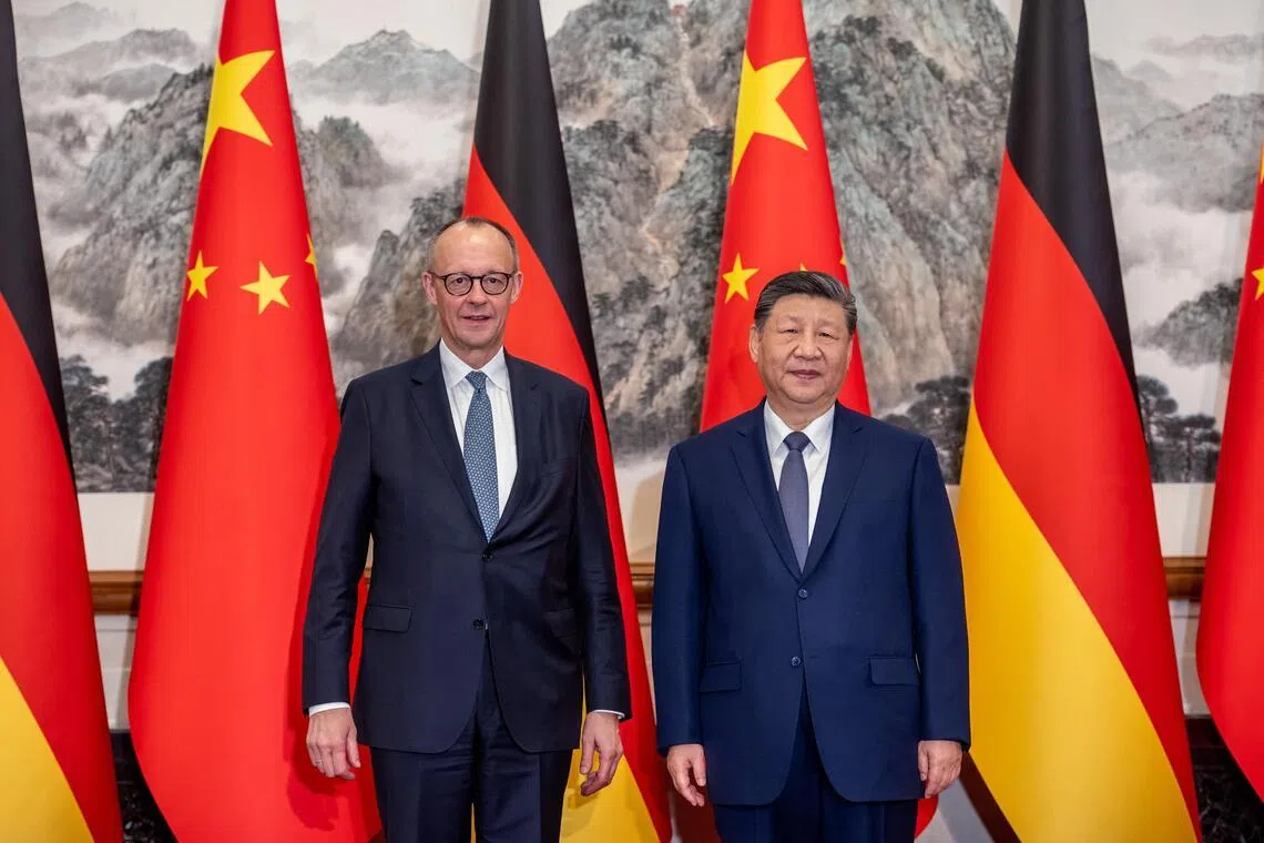 German Chancellor Friedrich Merz (left) and Chinese President Xi Jinping in Beijing on Feb 25. Instead of the West versus China, the real story concerns how middle powers are widening their economic options under Trump-era volatility while keeping their security anchoring intact.