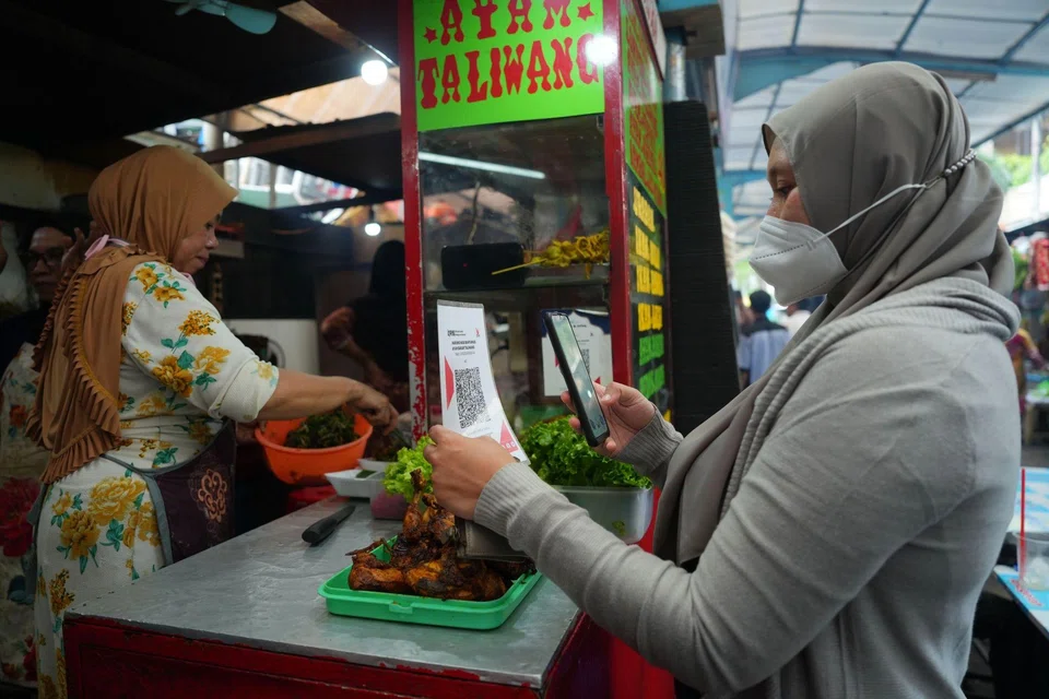 A customer scans a QR code to pay for a meal in Jakarta. Indonesia's Internet penetration stands at 77 per cent, up from just 13 per cent in 2009.