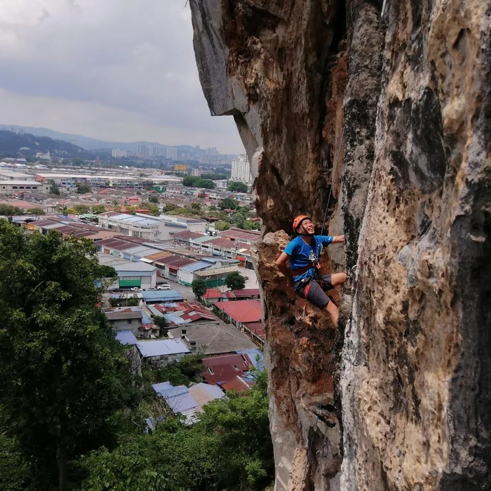 Rock climbing the Batu Caves' Nyamuk Wall, in  Malaysia, June 2022