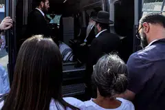 Jonathan Polin (R) and Rachel Goldberg (2nd-R), parents of US-Israeli hostage Hersh Goldberg-Polin whose body was recovered with five other hostages in Gaza, attend the funeral in Jerusalem on Monday Sep 2, 2024.