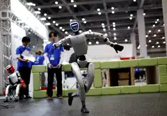 An android made by Unitree Robotics dancing at iREX 2025. When a robot-engendered crisis arises, there may be a temptation to frame the issue in the same terms as an immigration debate, says the writer.