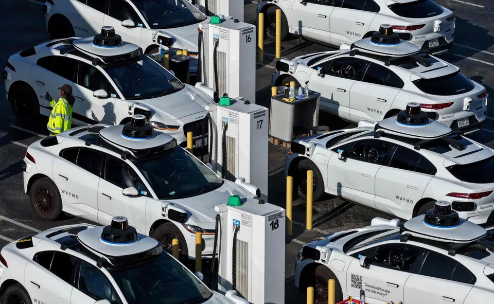 Waymo robotaxis sit parked at a Waymo facility in San Francisco, California, Dec 08, 2025.