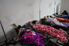 Students rest while receiving treatments for food poisoning after eating government-sponsored free school meals, at Cililin regional hospital in Bandung.