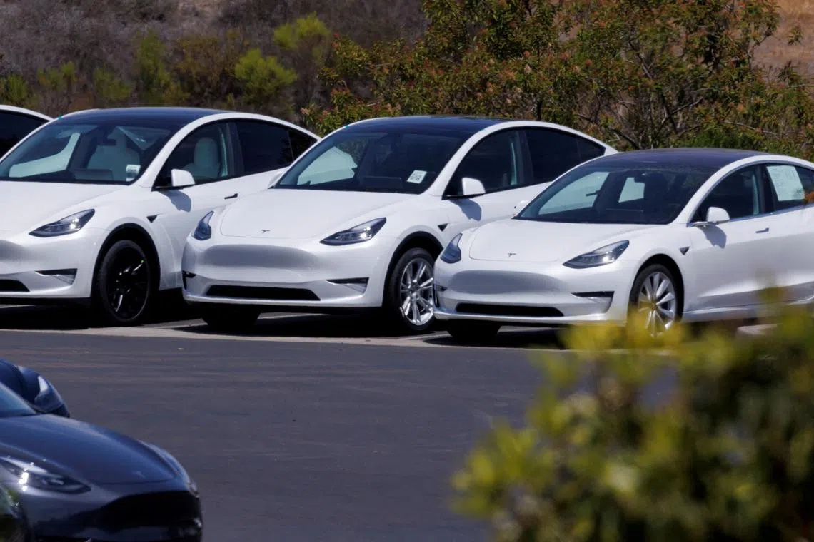 Tesla electric vehicles are shown at a sales and service center in California. Tesla was removed from the S&P 500 ESG index this year.