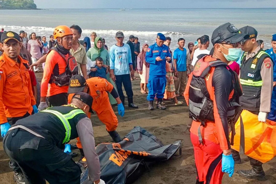 A rescue team moving a victim's body brought to shore earlier by local fishermen after a ferry sank on its way to the resort island of Bali, in Banyuwangi, East Java, Indonesia, July 3, 2025.