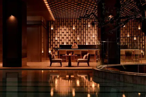 Aman’s Bangkok retreat, seen through water and shadow.