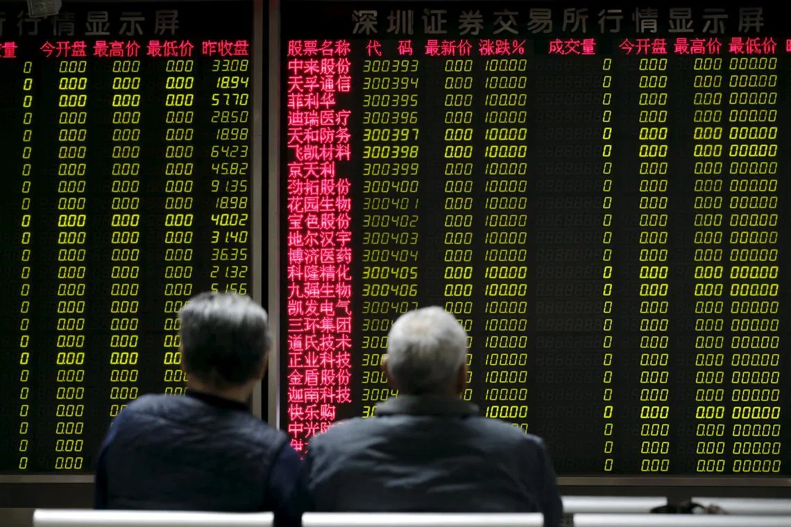 FILE PHOTO: Investors wait for China's stock market to open in front of an electronic board at a brokerage house in Beijing, China, January 8, 2016. REUTERS/Jason Lee