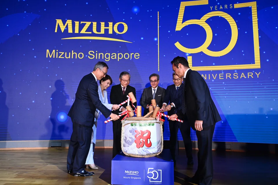 (From left) Mizuho Bank co-CEO for Asia Pacific Yasuhiro Kubota, Mizuho Bank Singapore CEO Josephine Lok, Deputy Prime Minister Gan Kim Yong, Mizuho Financial Group chairman Seiji Imai, Japanese Ambassador to Singapore Hiroshi Ishikawa and Mizuho Bank CEO for Asia-Pacific Koichi Zaiki at a sake-breaking ceremony.