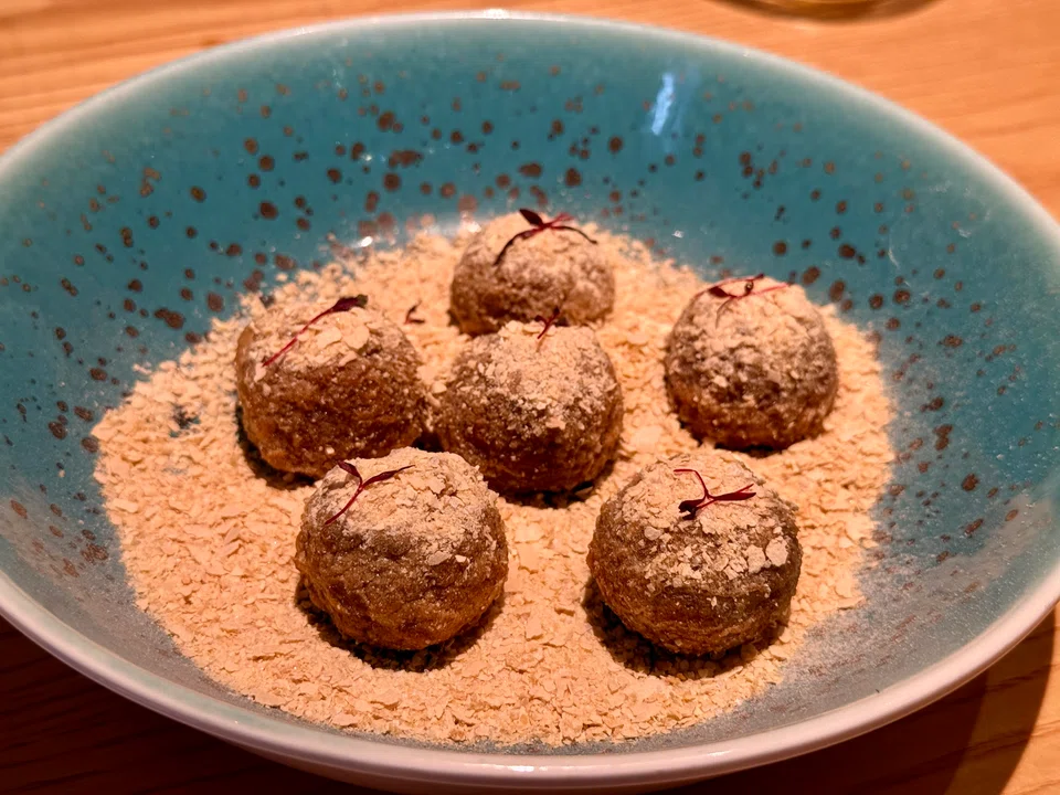 Brown sugar sticky rice balls are coated with Nestum breakfast cereal.