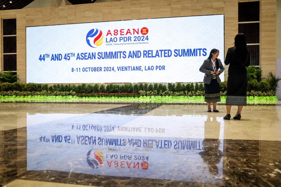 Delegates take photos amid the hustle and bustle of preparations in the National Convention Centre, where the summit meetings will be held.