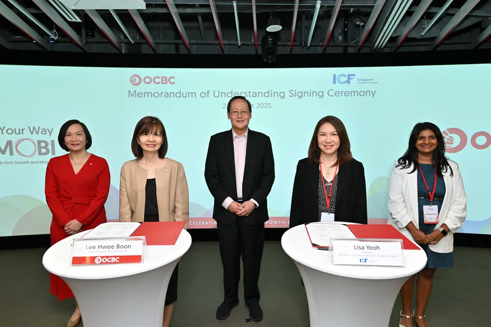 Manpower Minister Tan See Leng (third from left) and OCBC group CEO Helen Wong (first from left) witnessing the MOU signing for the partnership at the OCBC Campus in Tanjong Pagar.