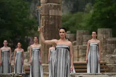 Greek actress Mary Mina, playing the role of the High Priestess, holds the torch after lighting it during the Olympic torch lighting ceremony for the Paris 2024 Olympics Games at the Ancient Olympia archeological site.