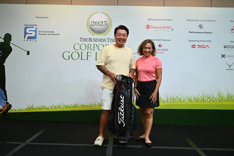Orchid Country Club golfer Alain Lee with BT's Head of Audio Claressa Monteiro at the prize presentation ceremony on Apr 10.