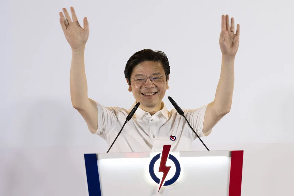 PM Wong waves to supporters at a party assembly centre in the early hours of May 4.