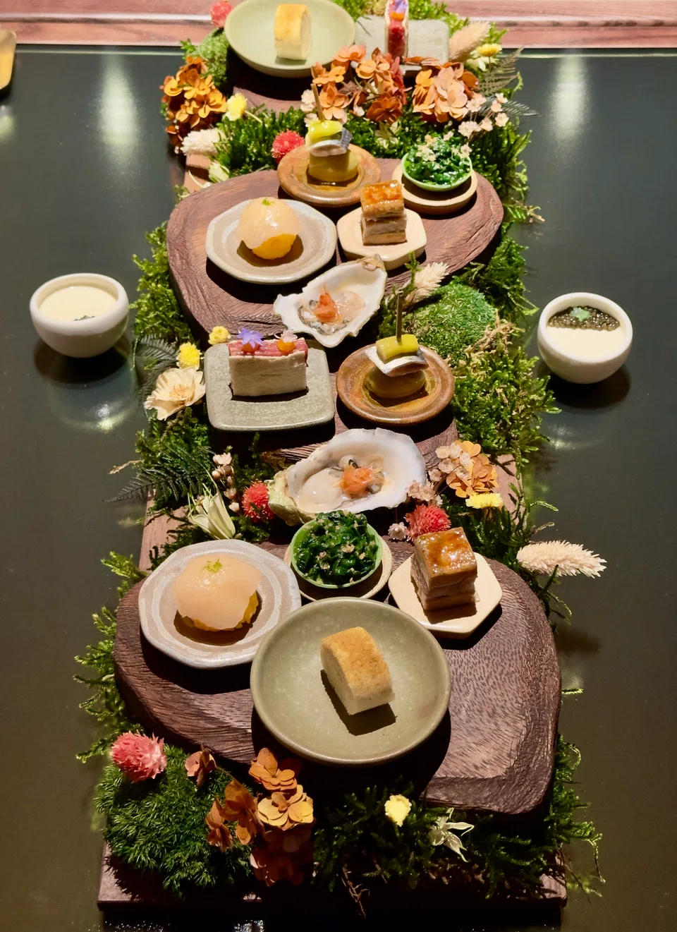 A generous spread of tapitas in a garden setting.