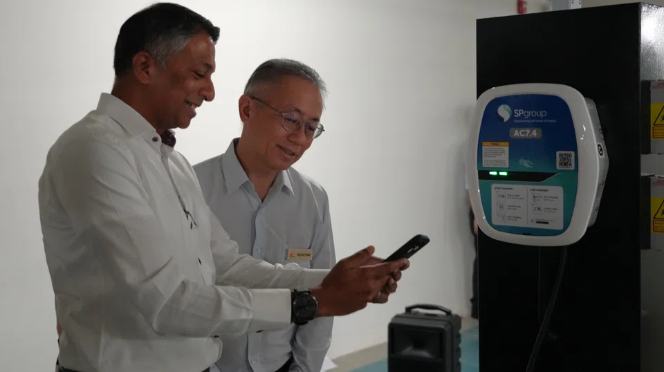 Senior officials of SP Group and SingHealth, who were at the inauguration of the 12 chargers on the Singapore General Hospital grounds on Friday (Jul 11), flipping the switch to start charging an EV used by SGH's campus security team. 