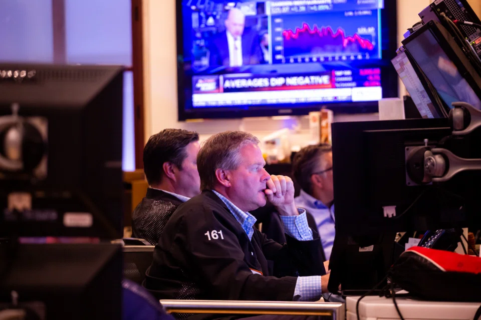 Traders work on the floor of the NYSE.. A desperation dip may occur in October followed by a strong rally.