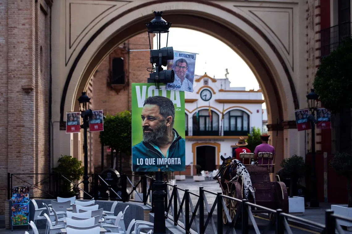 Campaign signs for the leaders of Spain's right-wing People's Party and far-right party Vox.
