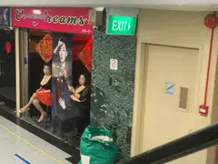 Two women sitting outside a beauty salon in Orchard Towers at lunchtime on Aug 25, 2022. 