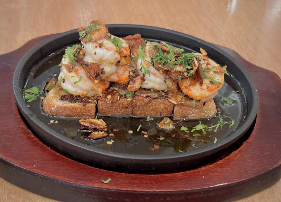 Garlic prawns sizzling on toast with homemade sambal.