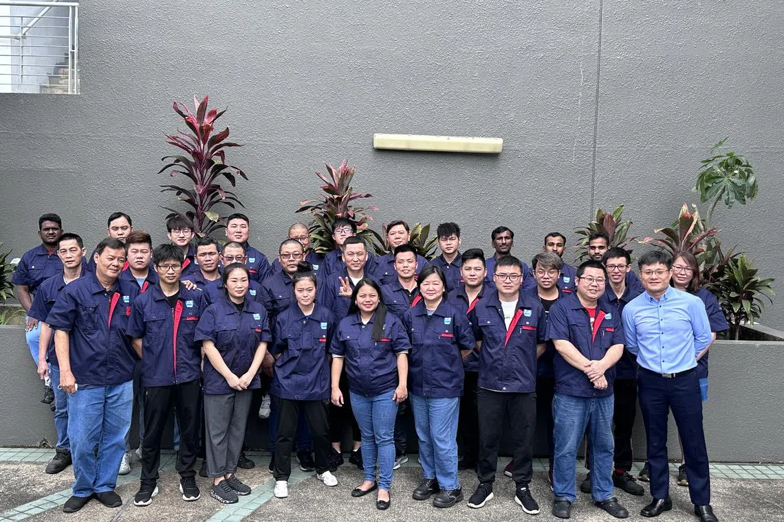 Jade Micron chief executive officer Jeff Wang (front row, extreme right) with his employees. Employee satisfaction and retention are key priorities for the company, said Wang.