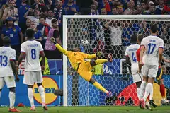 France's goalkeeper Mike Maignan concedes a goal by Spain's forward Lamine Yamal during the match between Spain and France in Munich, Germany on July 9, 2024. 