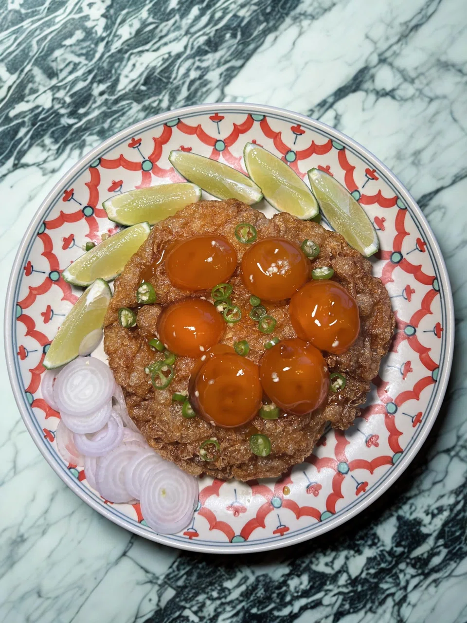 Egg white omelette topped with cured egg yolks.