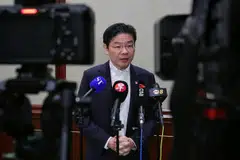 Prime Minister Lawrence Wong speaking to reporters during a media wrap-up in Hong Kong on Mar 28.