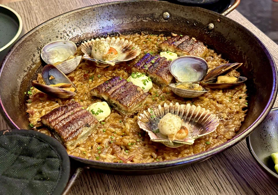 Seafood paella with unagi, scallops and clams.