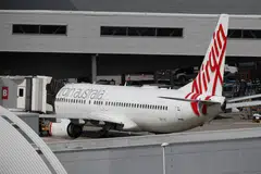 Qatar Airways is still awaiting government approval for its purchase of a 25 per cent stake in Virgin Australia from the US private equity firm Bain Capital.