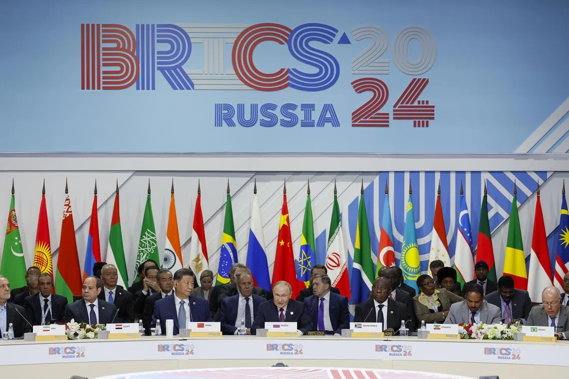 epa11679350 Russian President Vladimir Putin (C) speaks during a plenary session in the outreach/BRICS Plus format at the BRICS summit in Kazan, Russia, 24 October 2024. The BRICS summit takes place from 22 to 24 October.  EPA-EFE/MAXIM SHEMETOV / POOL