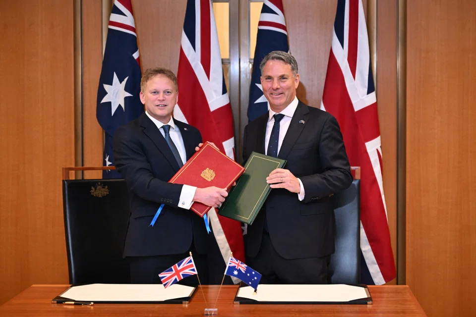(From left) UK Defence Minister Grant Shapps signed the agreement with his Australian counterpart Richard Marles during a ceremony in parliament in Canberra, Australia, March 21, 2024.  