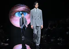 Models presenting Giorgio Armani creations under the piercing blue eye of the 89-year-old maestro, which was projected on the runway’s backdrop.