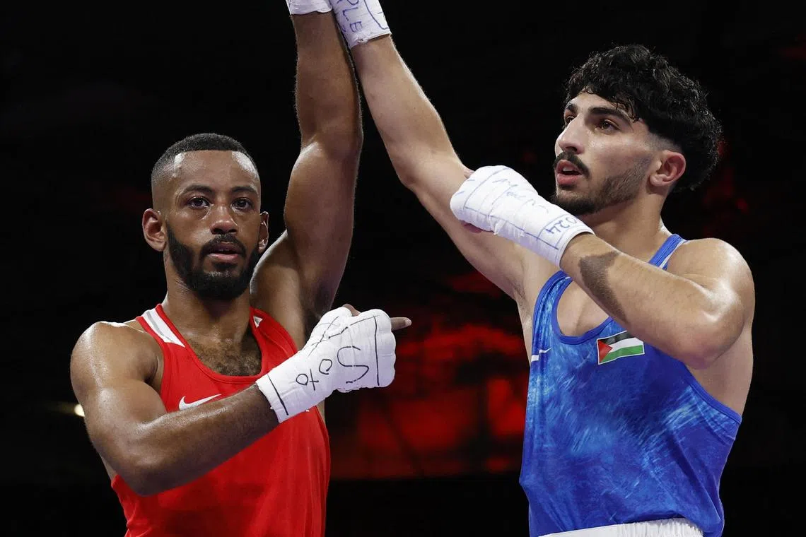 Palestinian boxer Wasim Abusal (right) found himself supported by a raucous crowd at the boxing venue when he lined up for his first bout in the preliminaries.
