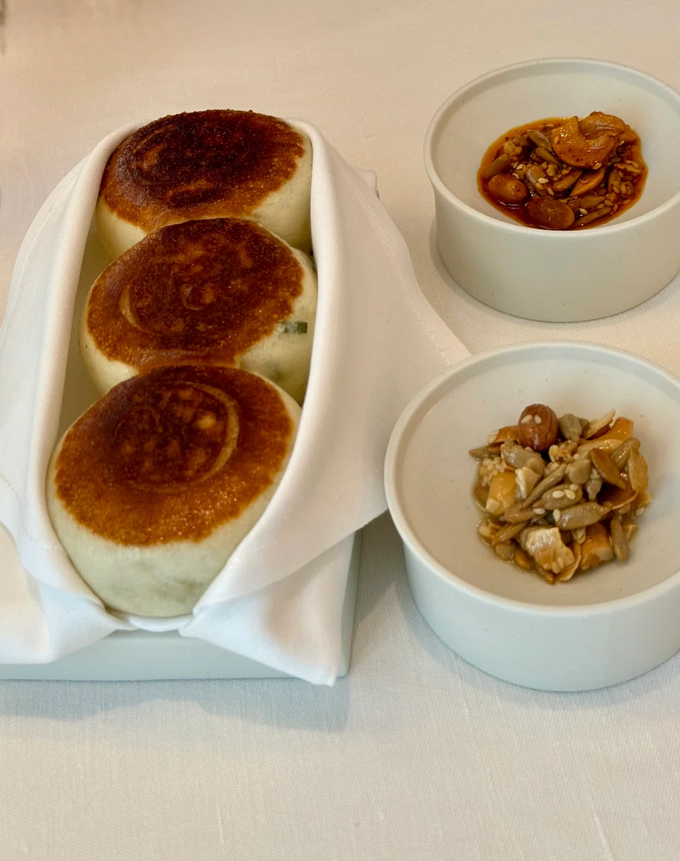Steamed and seared buns with mixed seeds relish.