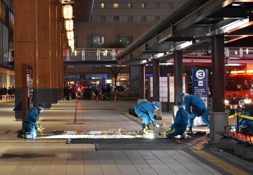Investigators inspect the crime scene outside the JR Nagano train station after a man stabbed three people at a bus stop in Nagano, Japan, Jan 22, 2025. 