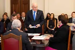 New Zealand's new Prime Minister Christopher Luxon (C) takes an oath before New Zealand's Governor General Dame Cindy Kiro (R) during the swearing-in of the new government at Government House in Wellington on Nov 27, 2023. 