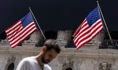 epa11520221 A person walks past American flags hanging on the front of the New York Stock Exchange in New York, New York, USA, 02 August 2024. The United States Bureau of Labor Statistics released an 'Employment Situation Summary' reports on 02 August that the unemployment rate in the United States rose to 4.3 percent in July 2024. Investors reacted negatively to the economic news, leading the Dow Jones industrial average to lose over 800 points during the day.  EPA-EFE/OLGA FEDOROVA