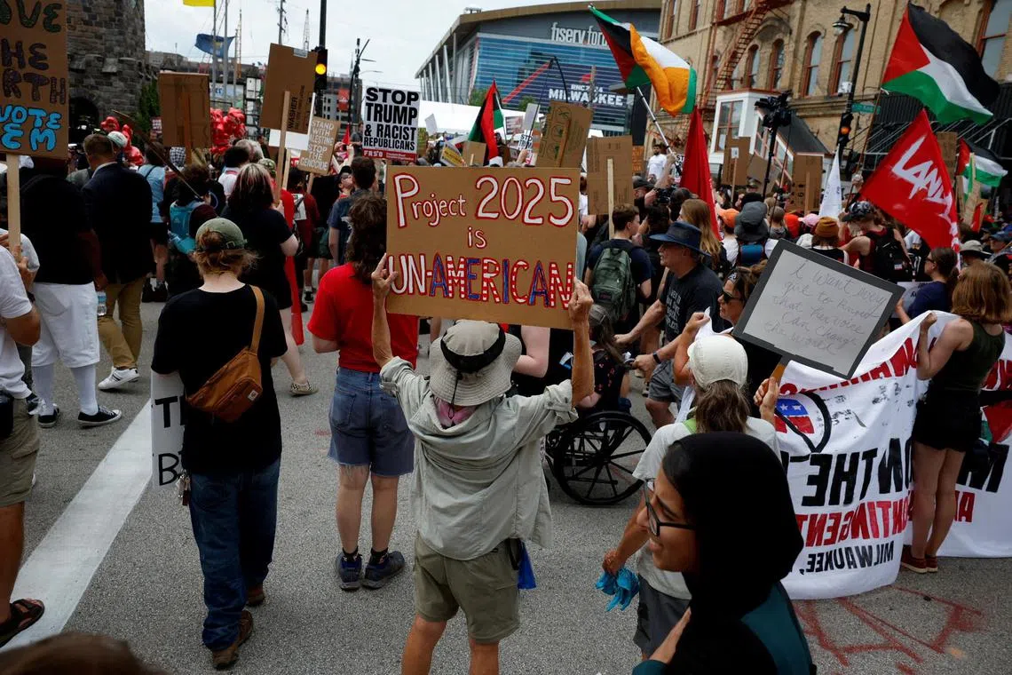 A woman holding a placard reading "Project 2025 is un-American" in an anti-Trump protest outside the venue of the Republican National Convention in Milwaukee, Wisconsin, Jul 15. 