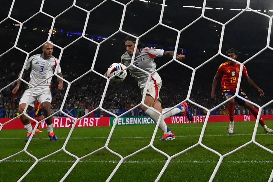 Italian defender Riccardo Calafiori (centre) hits the ball into his own net for the only goal of the game, an own goal during the match between Spain and Italy in Gelsenkirchen, Germany, June 20, 2024.