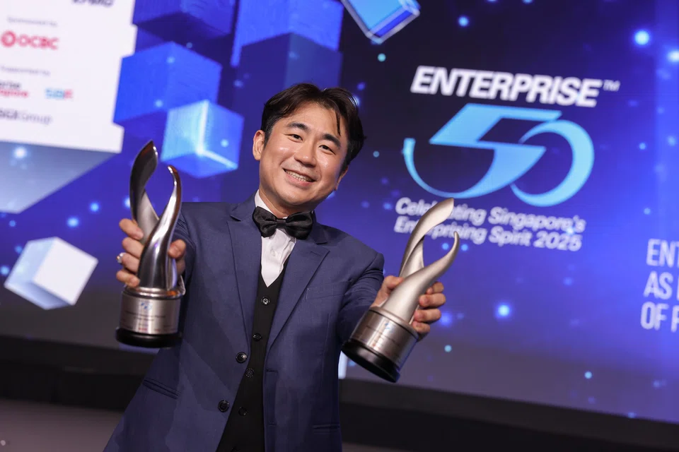 Sherman Ng, sales & marketing manager of MaxSteel Enterprise with the two trophies for the 2025 E50 Awards and the Special five-year award.
