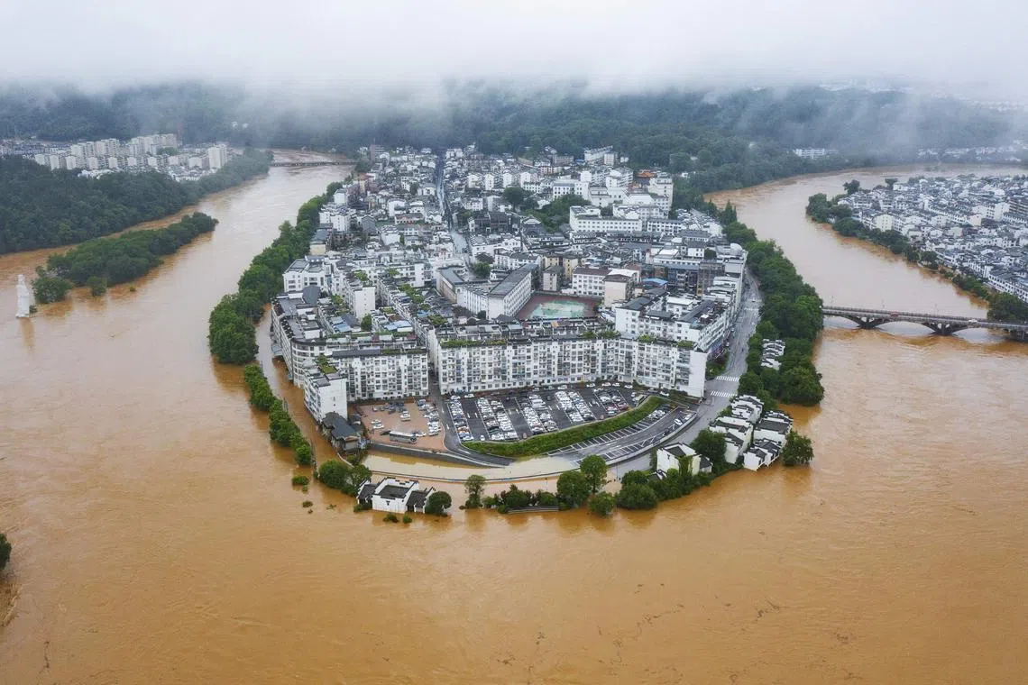 An aerial photo taken on June 20, 2022 showing flooded streets and buildings following heavy rains in Wuyuan, in China's central Jiangxi province.