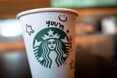 The same week that Starbucks' cup-writing policy went into effect, it cut more than 1,000 corporate jobs and said it would outsource some of its technology work. 