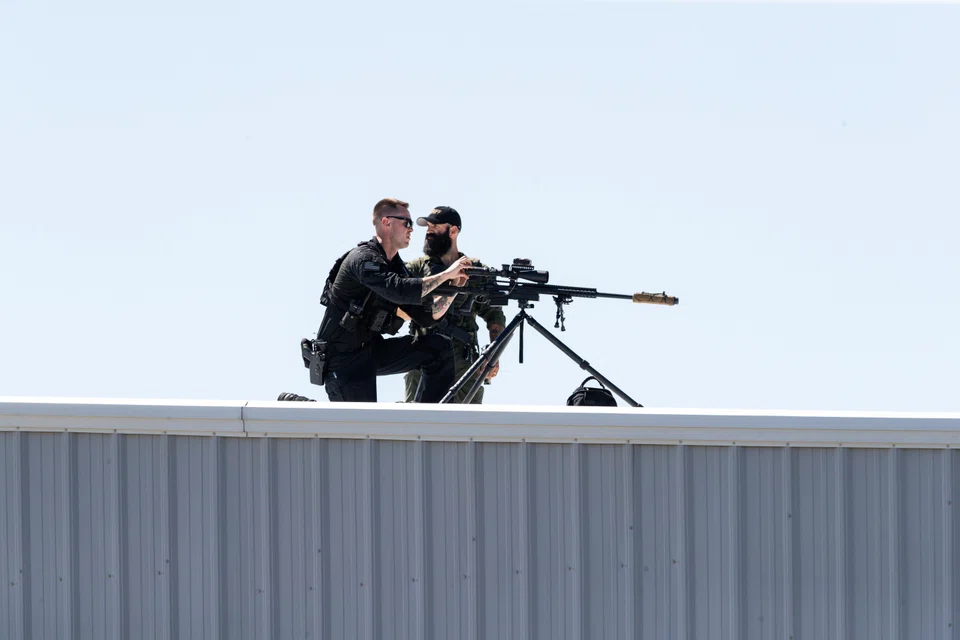 Secret Service sniper teams setting up before a Trump rally; he has complained that the Democrats made him a target by calling him a threat to democracy.