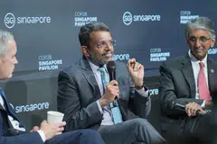 Monetary Authority of Singapore's managing director Ravi Menon (centre), Temasek's chief executive officer Dilhan Pillay (right) and Glasgow Financial Alliance for Net Zero's co-chair Mark Carney (left) speaking at the sidelines of the United Nations climate change conference in Dubai on Monday (Dec 4). 