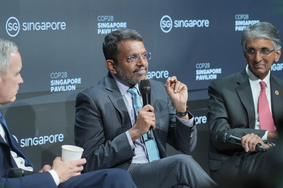 Monetary Authority of Singapore's managing director Ravi Menon (centre), Temasek's chief executive officer Dilhan Pillay (right) and Glasgow Financial Alliance for Net Zero's co-chair Mark Carney (left) speaking at the sidelines of the United Nations climate change conference in Dubai on Monday (Dec 4). 