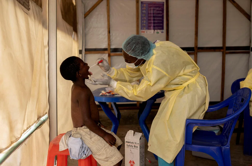 A laboratory nurse takes a sample from a child suspected of having Mpox at a treatment centre in Munigi, Democratic Republic of Congo, July 19, 2024. 